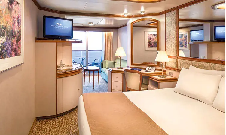 The stateroom has separate seating area with sofa.