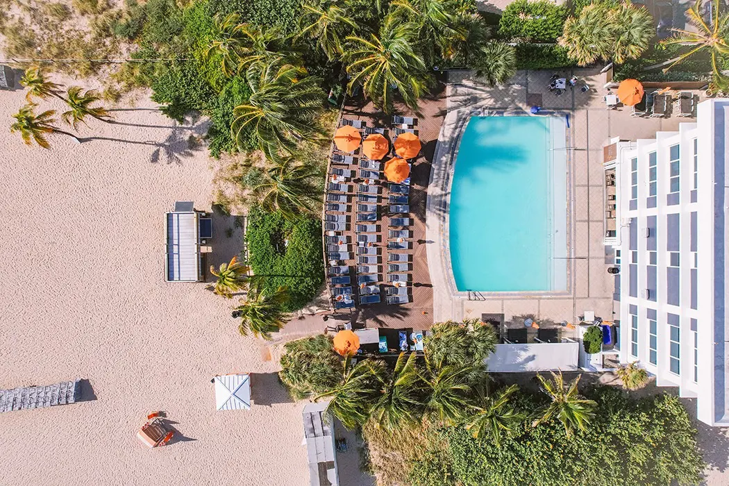 A bird's eye view of B Ocean Resort featuring hotel building, beach and outdoor pool