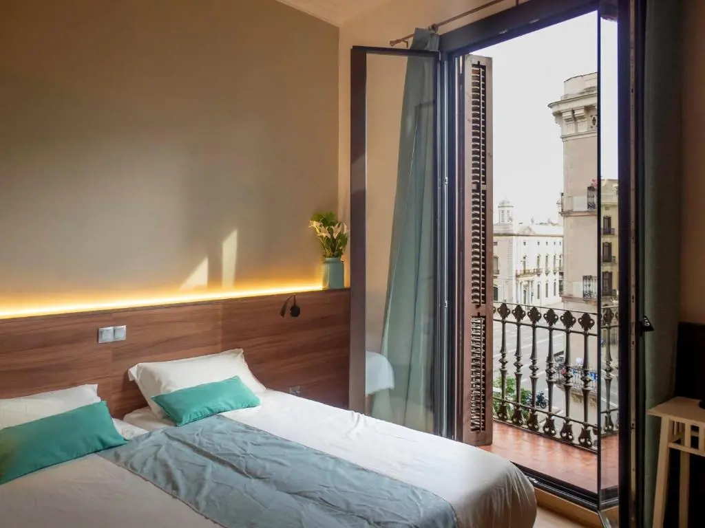 Pension Ciudadela room with balcony view to Barcelona city buildings.