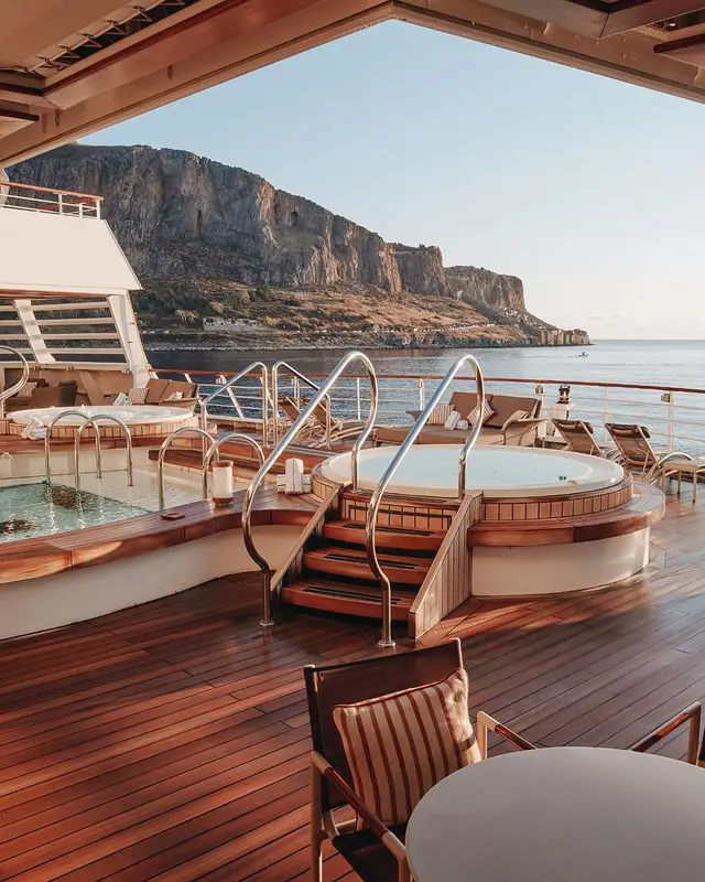 The Seabourn pool surrounded by an expansive sundeck with chaise lounges