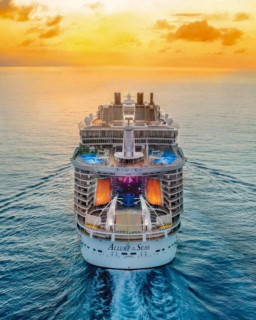 Allure of The Seas sailing on a beautiful sunset.