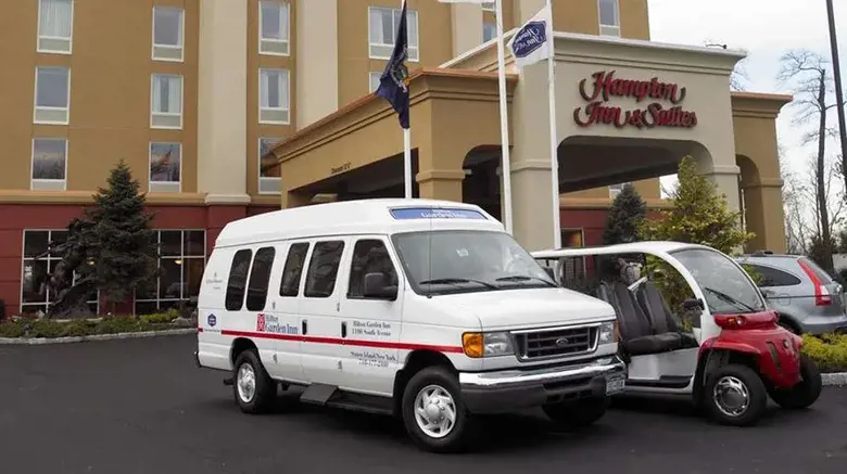 Hampton Inn & Suites Staten Island building pictured with shuttle vehicles by Ice Portal